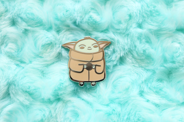 Baby Yoda Pin on Blue Fabric Background