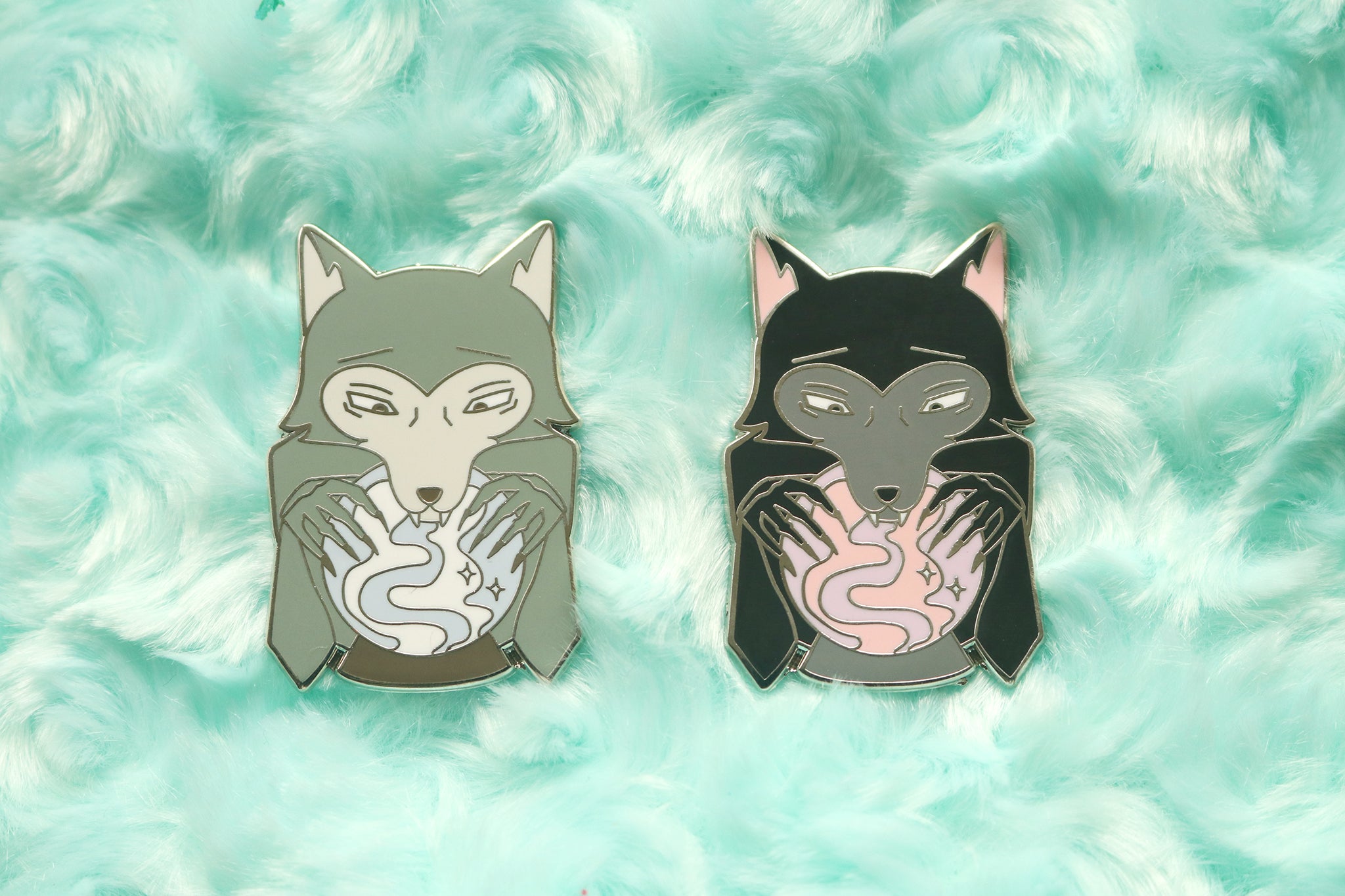 Enamel pins depicting a wolf looking into a crystal ball.
