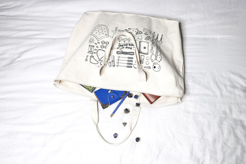 white bag of holding canvas tote bag with tabletop RPG supplies inside