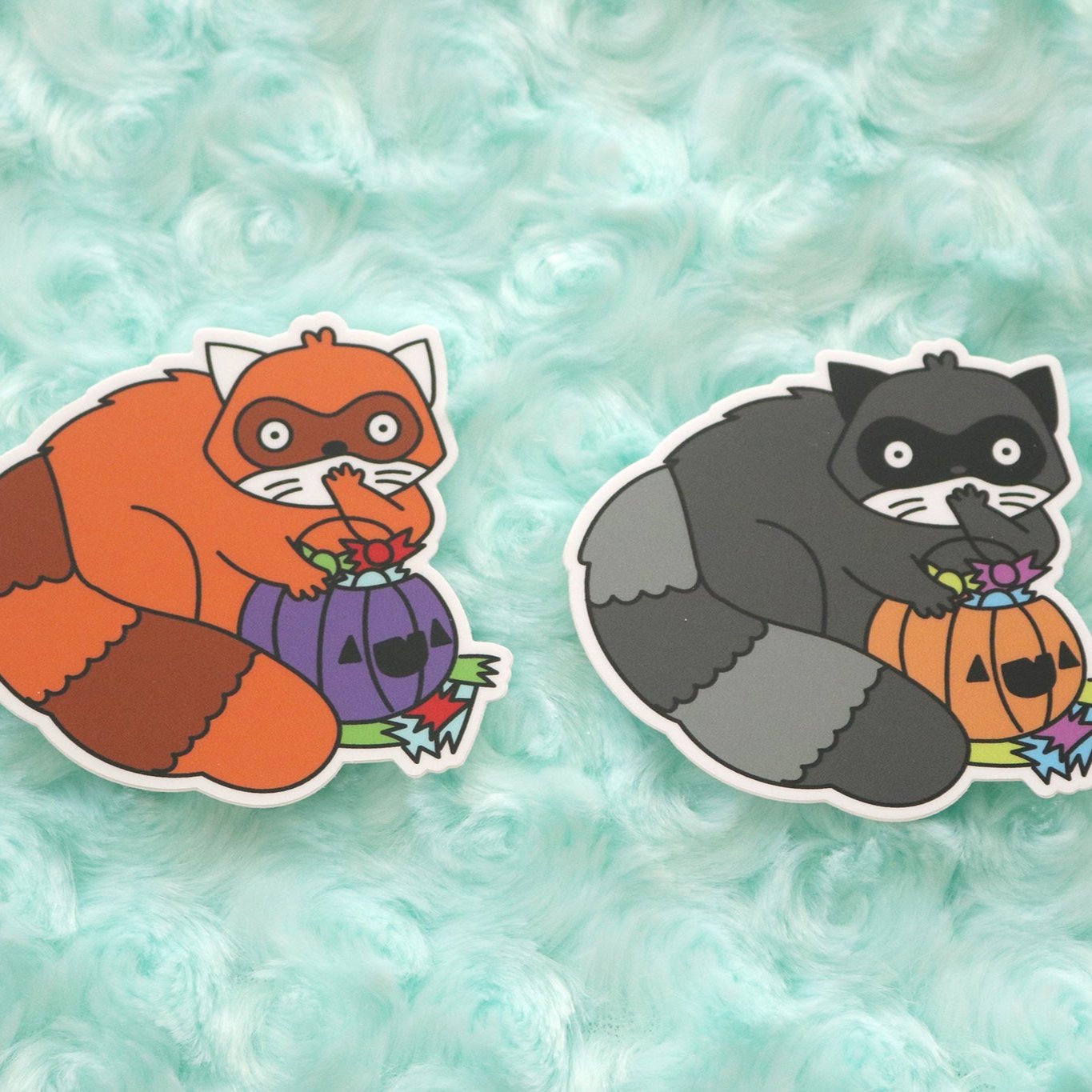 Red Panda and Raccoon Vinyl Stickers. Both animals looked shocked because they've been caught with their dirty paws in the halloween candy stash!